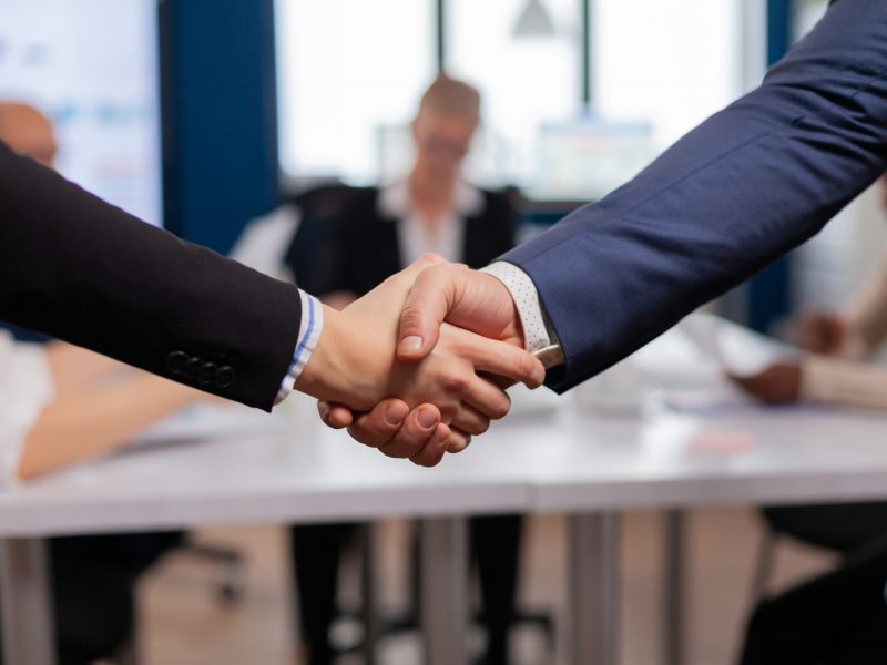 Satisfied businessman company employer wearing suit handshake new employee get hired at job interview, Man hr manager employ successful candidate shake hand at business meeting, placement concept